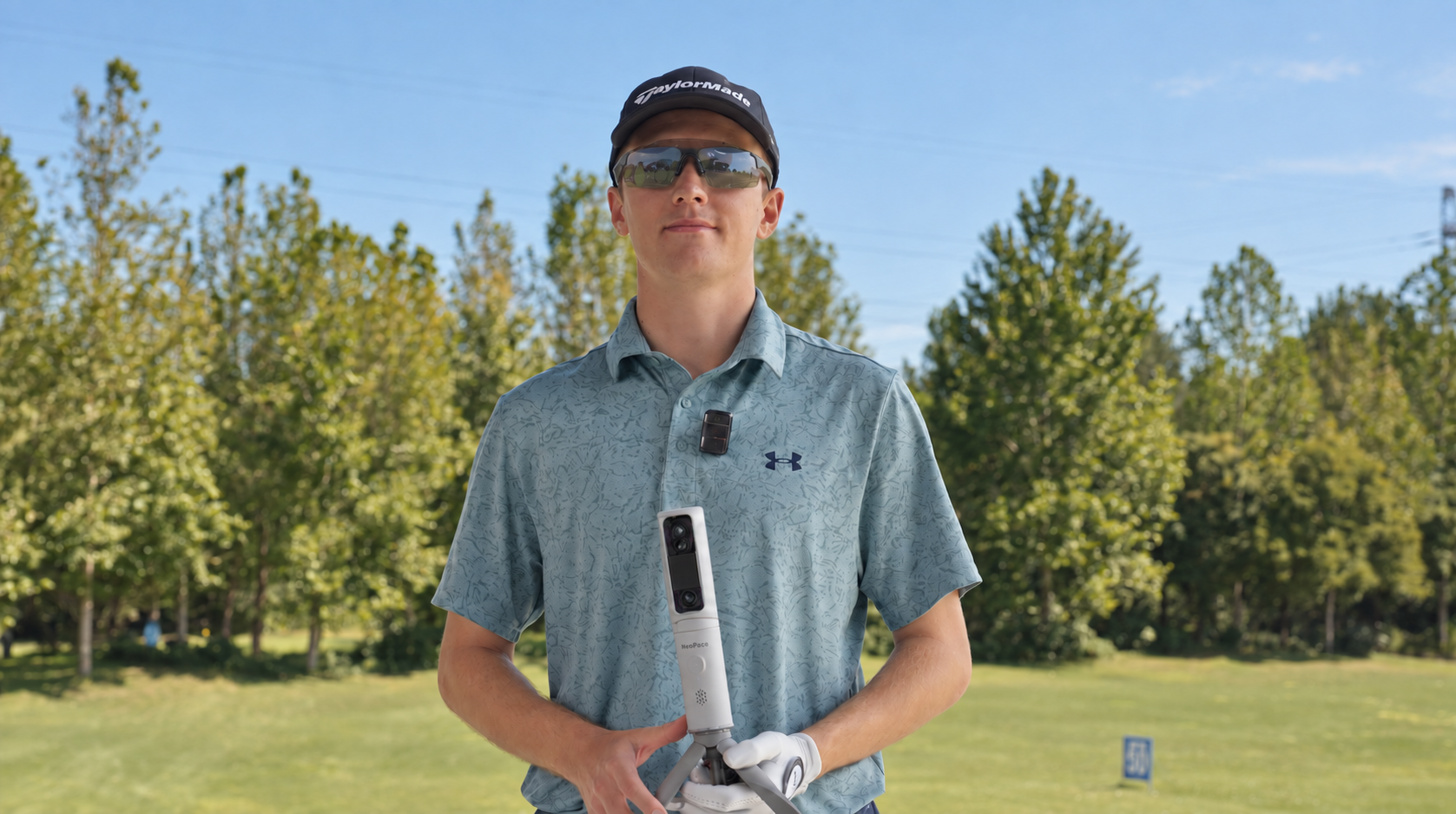 John George Mckenna holding NeoPace on a golf course